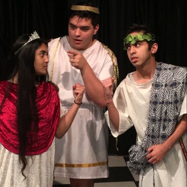 Student actors in ancient Grecian robes. 